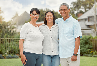 Buy stock photo Shot of a woman and her parents standing outside in a yard
