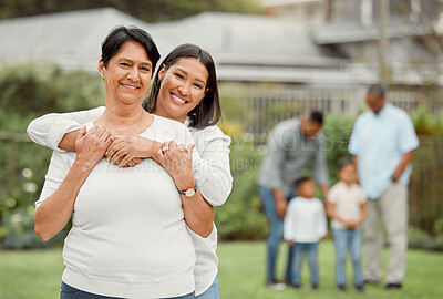 Buy stock photo Shot of a mother and daughter holding each other outside