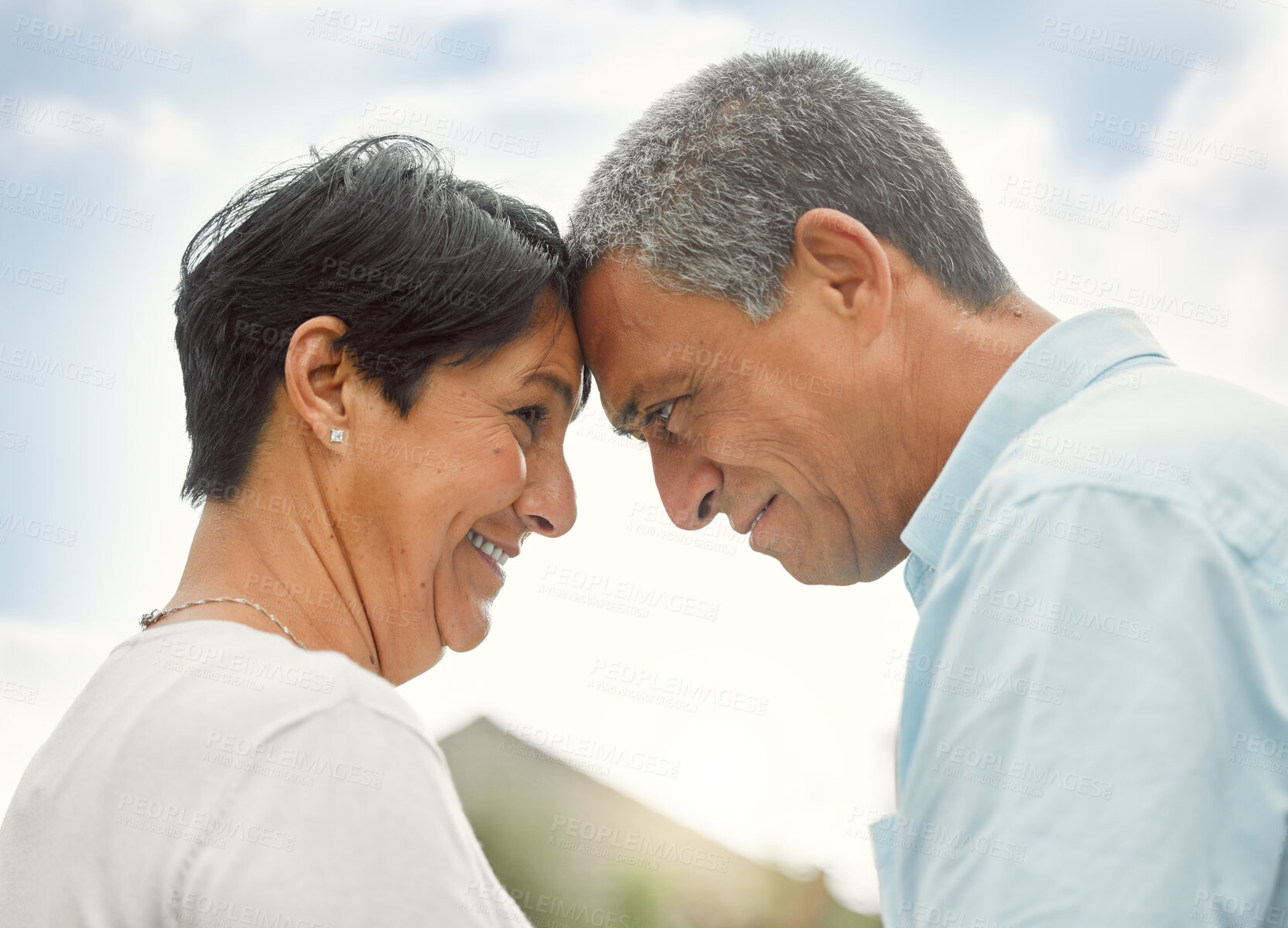 Buy stock photo Love, forehead touch and mature couple in nature for romance, care or bonding. Smile, man and woman together outdoor for connection, commitment or support for healthy relationship on anniversary date