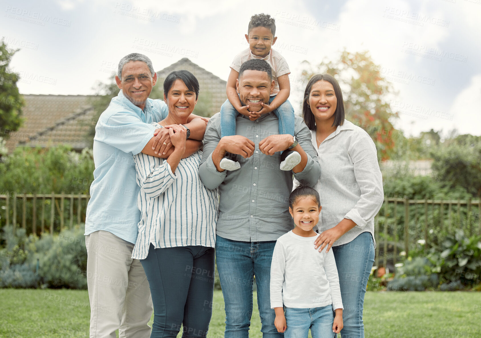 Buy stock photo Shot of a family in the backyard at home