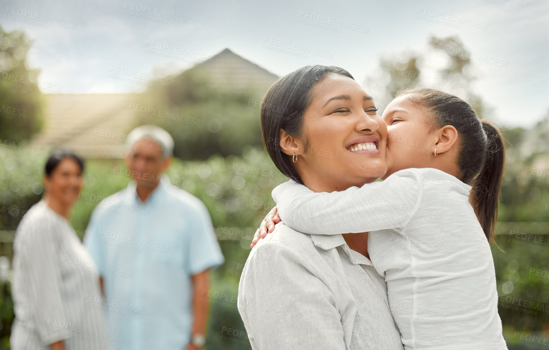 Buy stock photo Shot of an adorable little girl embracing her mother at the park