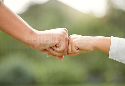 Buy stock photo Shot of a unrecognizable mother and son fist bumping outside