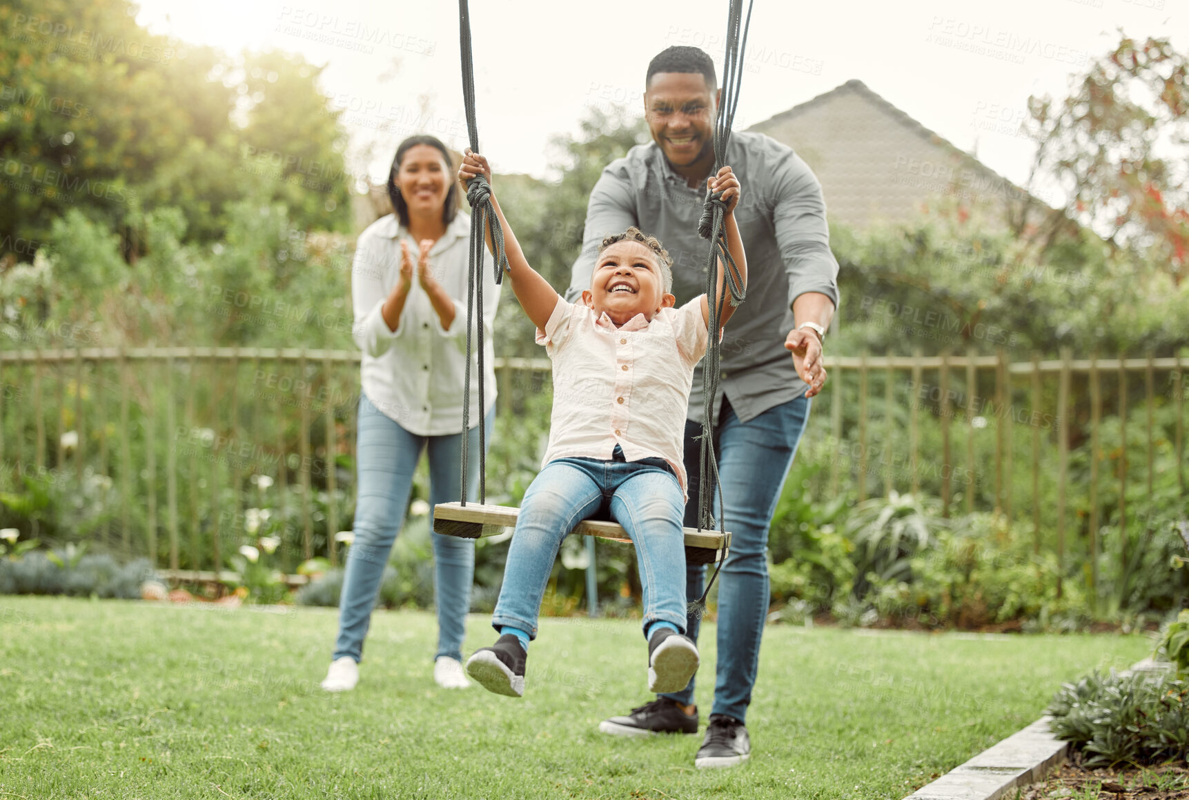 Buy stock photo Swing, parents and family with boy in park, happiness and bonding together with nature, smile and fun. Playground, mother and father with son, childhood and kid with break, excited and cheerful