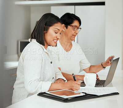 Buy stock photo Shot of a young woman using a laptop with her elderly mother while going through finances at home