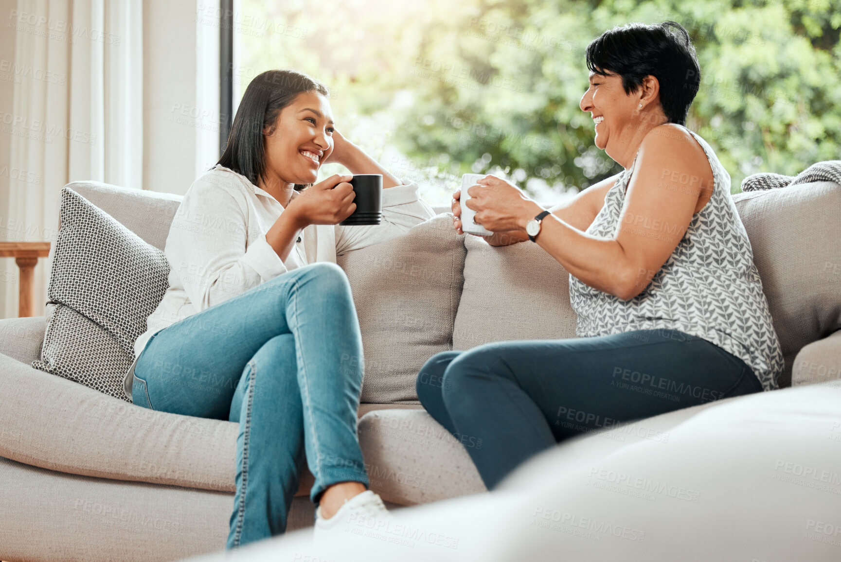 Buy stock photo Shot of a senior woman bonding with her daughter on the sofa at home