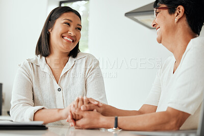 Buy stock photo Shot of a senior woman boding with her daughter while sitting at the kitchen counter