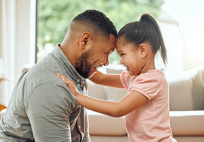 Buy stock photo Shot of a young father and daughter bonding together at home