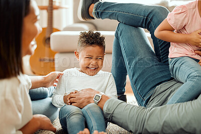 Buy stock photo Laugh, family and children relax in living room for bonding, love and child development. Happy parents, home play and mother, father and kids on floor having fun with tickling for learning and games