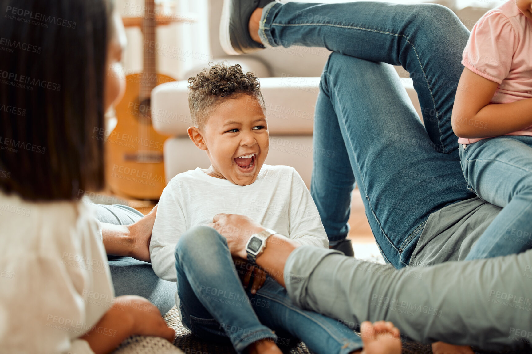 Buy stock photo Playing, family and children relax in living room for bonding, love and child development. African parents, home and mother, father and kids on floor having fun with tickling for learning and games