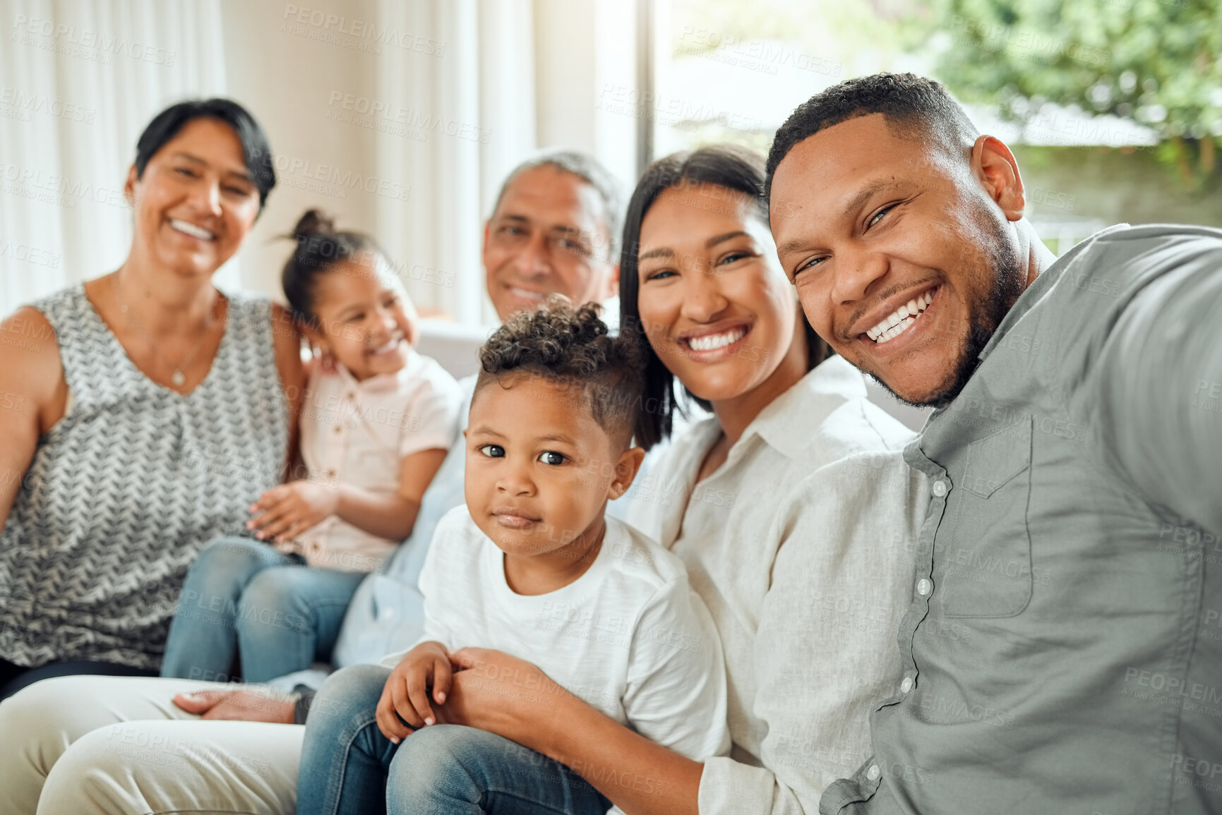 Buy stock photo Family in selfie, grandparents and parents with children relax with smile, generations and bonding at home. People are happy in picture together in living room, love and care with support and trust