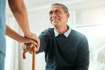 Buy stock photo Cropped shot of a nurse helping an older man stand up and use his walking stick