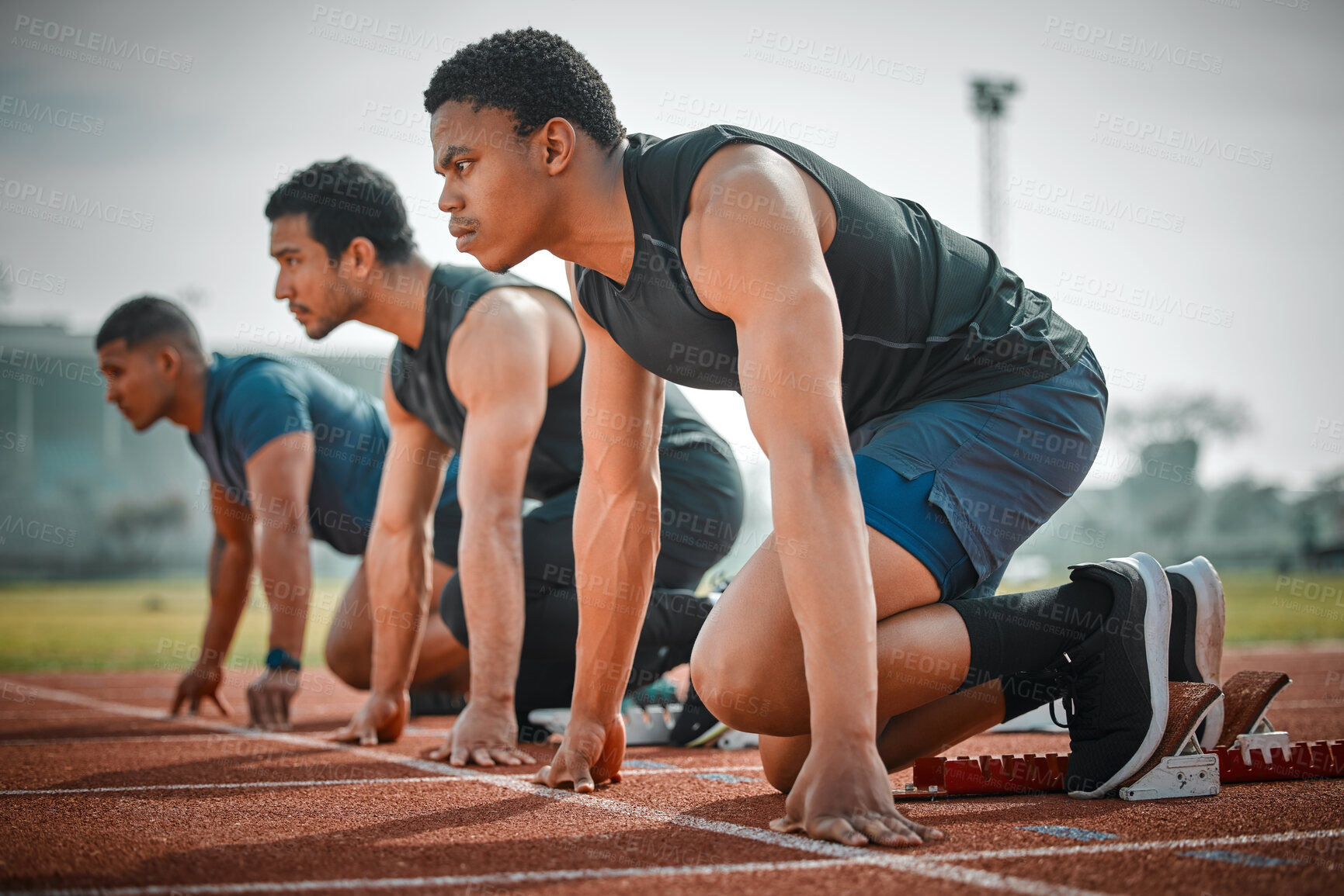 Buy stock photo Start, block and group of men race at track for speed challenge, marathon event and professional sports arena. Ready, set and people at stadium for competition, fitness and distance running athlete