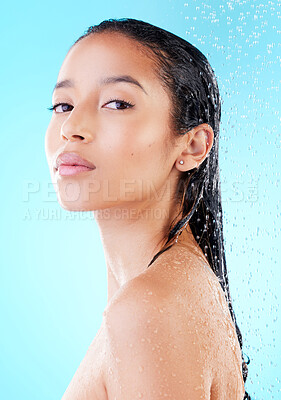 Buy stock photo Portrait, shower and woman with water splash, wet and grooming routine on blue studio background. Person, model and girl with liquid, shine or washing with dermatology, wellness or pamper for hygiene