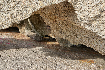 Buy stock photo Large boulder or sandstone with rough nature textures and natural indents. Closeup of rock or granite structure with colorful particles shining in the sunlight. Geology wonders of South Africa