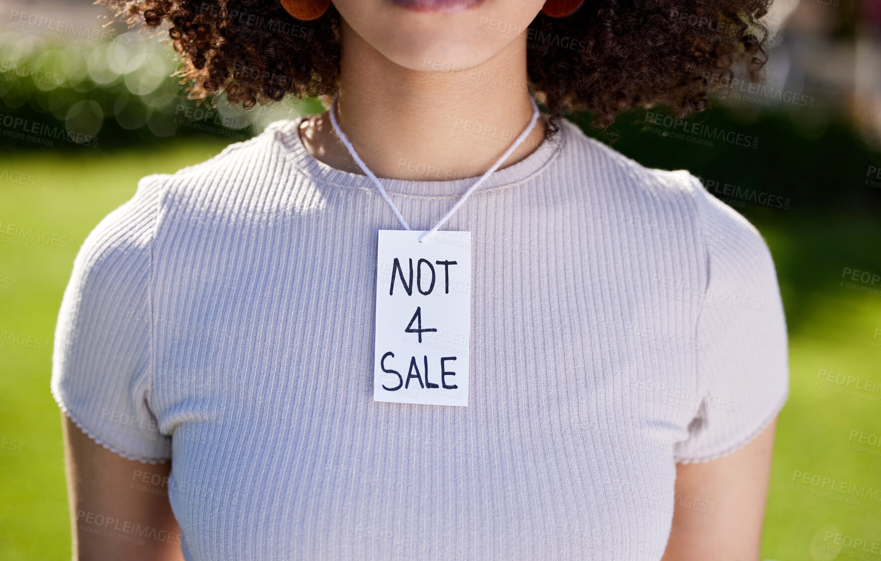 Buy stock photo Shot of a unrecognizable woman wearing a sing on her neck in protest outside