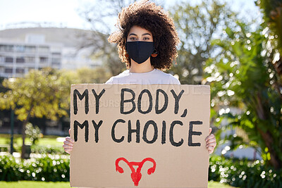 Buy stock photo Shot of a unrecognizable woman protesting outside in the park