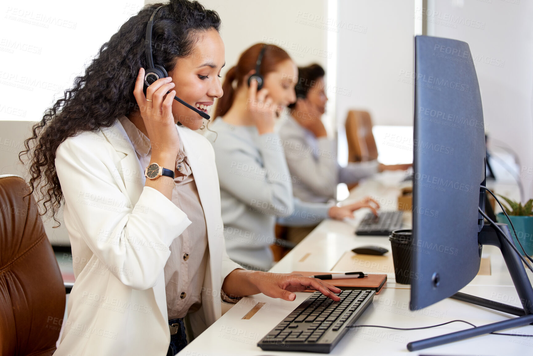 Buy stock photo Agent, woman and headset with smile on computer for call center or customer care in office with coworkers. Female person, technology and operator for telecommunication, company and workplace or job