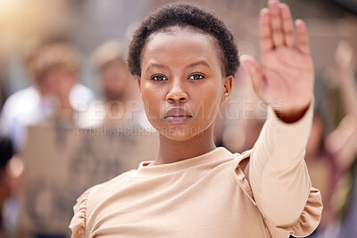 Buy stock photo Shot of a young woman holding her hand up to stop at a protest