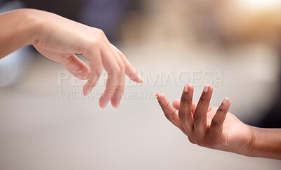 Buy stock photo Shot of two people reaching out to one another