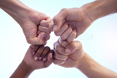 Buy stock photo Shot of a group of people fist bumping one another in a circle
