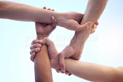 Buy stock photo Shot of a group of diverse people with their arms interlinked