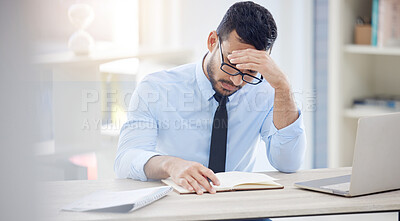 Buy stock photo Headache, man and notebook in office for deadline, debt and overworked in workplace. Male lawyer, frustrated and laptop at desk with anxiety, burnout and tired at desk from workload, pressure or work