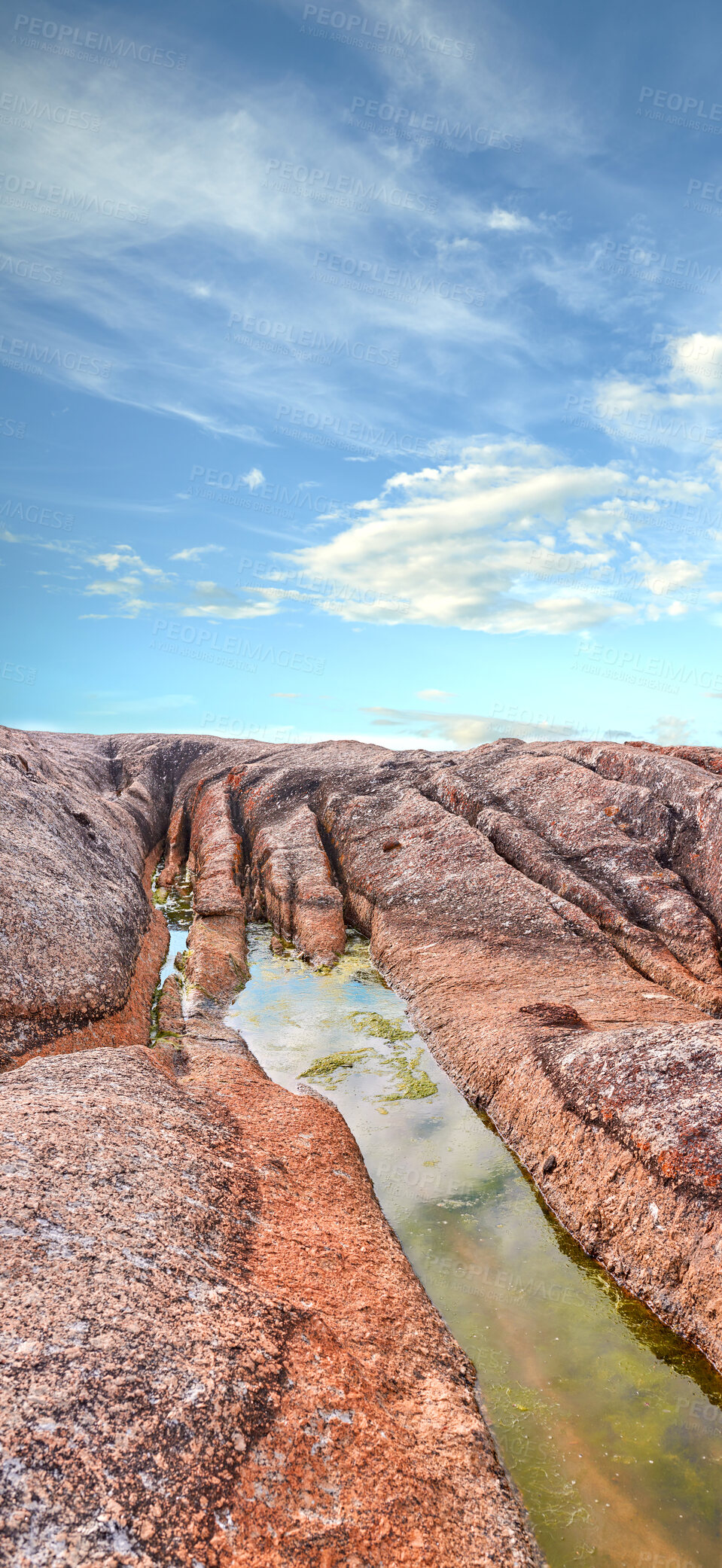 Buy stock photo Stream, water or inlet on rocky terrain outside under cloudy blue sky copyspace during summer. Nature, the wilderness and freedom on a sunny day for eco friendly environmentalism and conservation