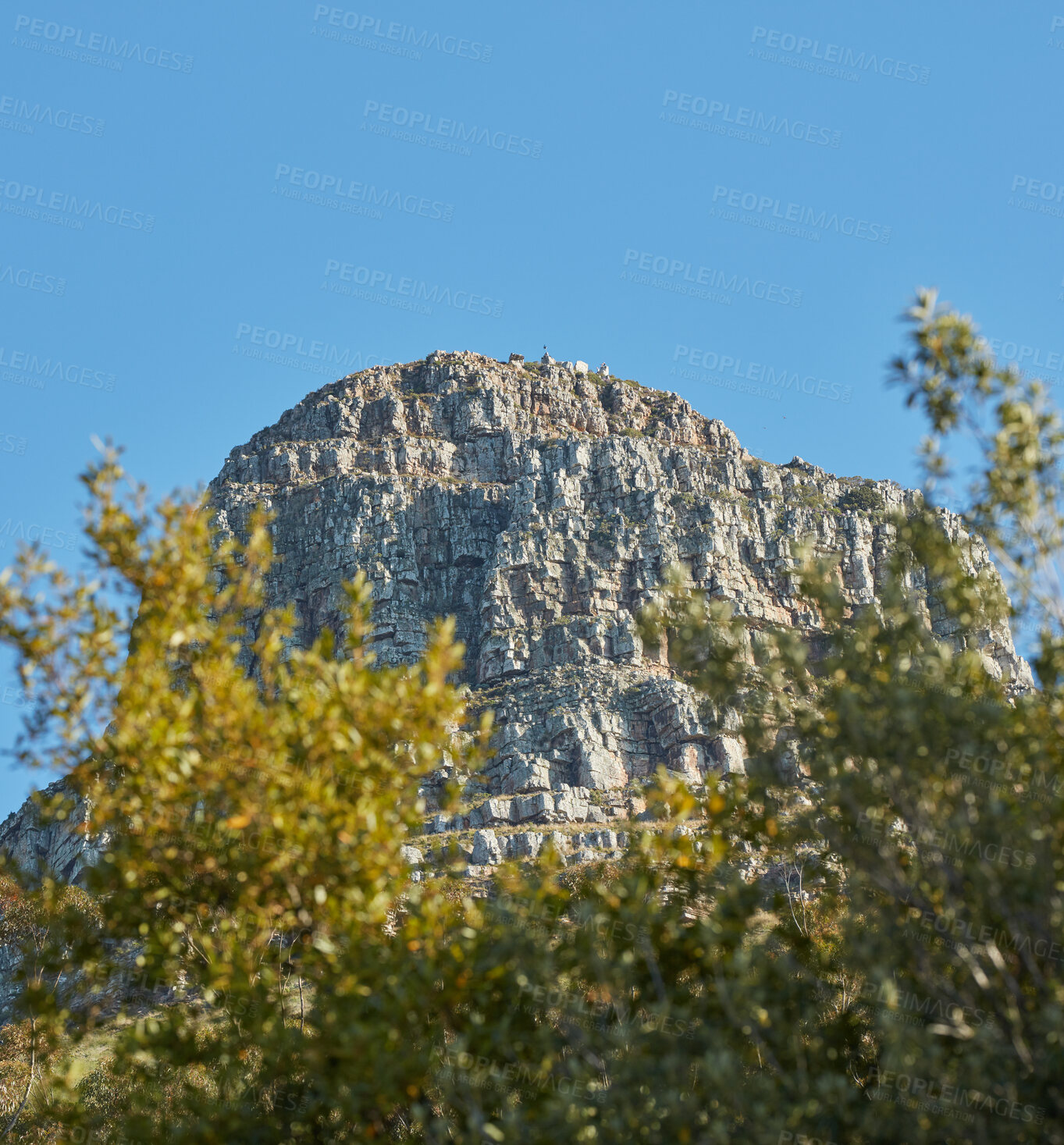 Buy stock photo Landscape of rocky mountain with boulders against a blue sky in summer. Green field with rocks and wild grass growing on sunny day outside with copy space. Scenic remote travel destination in nature 