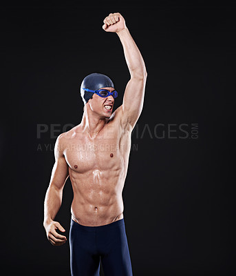 Buy stock photo Celebration, fist and male swimmer in studio with goggles for swimming, success and exercise on dark background. Victory, athlete and man with cap for challenge, champion and water competition 