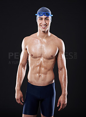 Buy stock photo Man, studio and portrait for swimmer fitness, workout and exercise with athlete for cardio health. Wellness, confident and male person with swimming cap and goggles, black background for sport