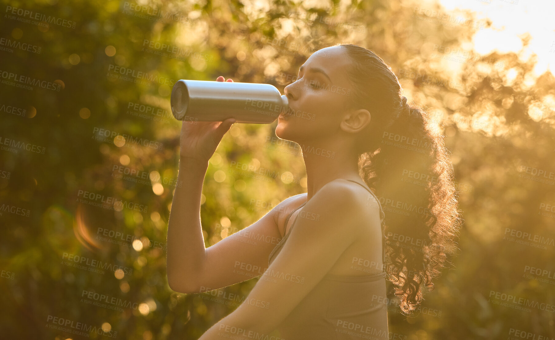 Buy stock photo Fitness, woman and drinking water in nature for sustainability, healthy wellness or break from exercise. Calm female person, athlete or runner with drink for hydration after cardio workout in forest