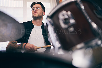 Buy stock photo Man, drummer and artist in house with drums in band as musician in playing an instrument. Male person, event and percussion as creative for ideas, song or lyrics in online content or live performance