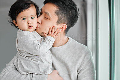 Buy stock photo Shot of a young man bonding with his adorable baby girl