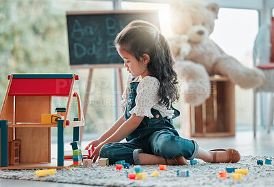 Buy stock photo Girl, dollhouse and child play in home, games and fantasy for brain development or lounge. Female person, toys and blocks on floor for entertainment, growth and toddler for education or learning