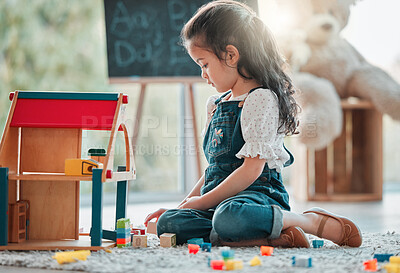 Buy stock photo Girl, tiny house and child play in home, games and fantasy for brain development in lounge. Female person, toys and blocks on floor for entertainment, growth and toddler for education or learning