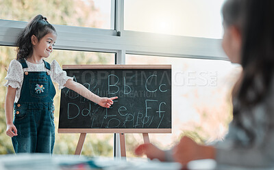 Buy stock photo Home, little girl and blackboard with alphabet for education, studying and foundation for literacy. House, children and pointing at abc for learning, language development and montessori for preschool