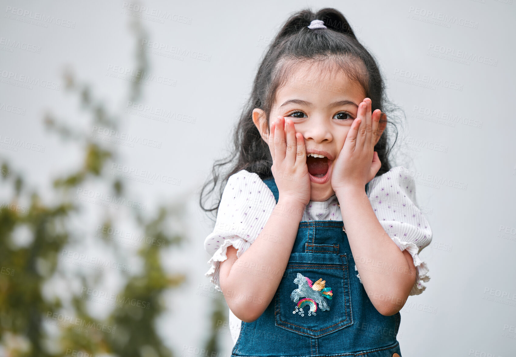 Buy stock photo Shot of an adorable little girl looking surprised while standing outside