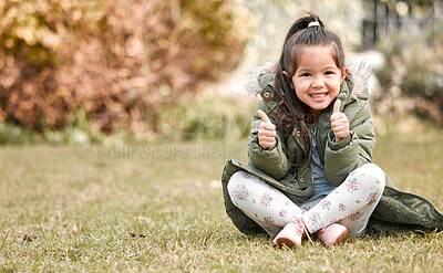 Buy stock photo Shot of an adorable little girl  showing thumbs up while sitting outside