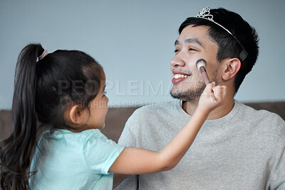 Buy stock photo Shot of a playful little girl applying make-up to her father's face
