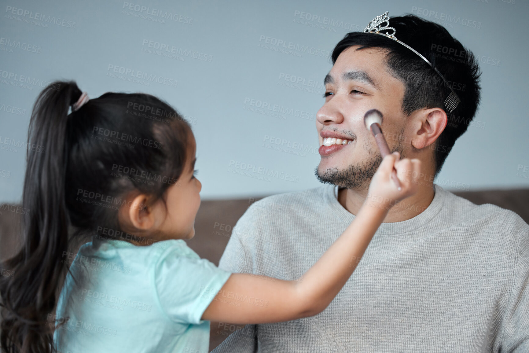 Buy stock photo Girl, father and brush for makeup, fun and bonding together in home with powder, crown and happy dad. Asian family, daughter and man in house for love, game and childhood with care, smile and funny