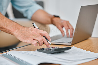 Buy stock photo Cropped shot of an unrecognisable man sitting alone on his sofa and using his laptop while calculating his finances