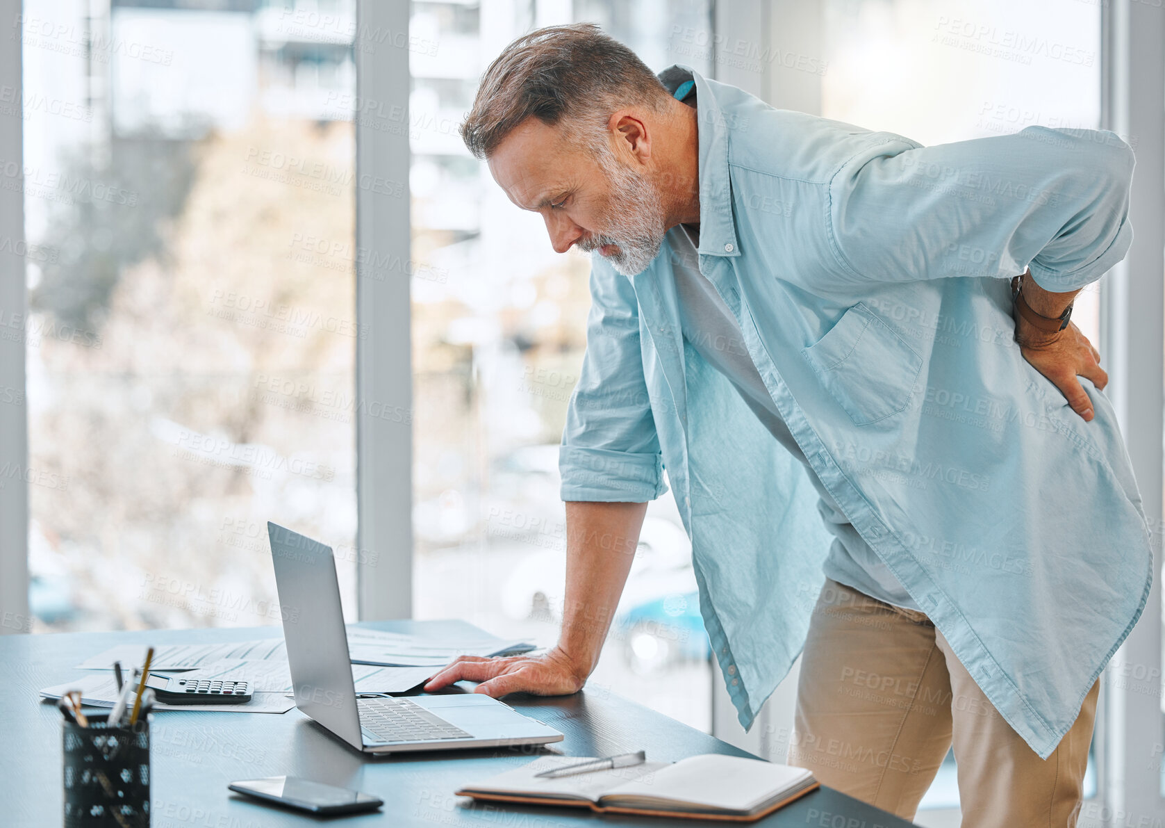 Buy stock photo Desk, business and mature man with back pain for injury, muscle tension or overworked. Remote work, health emergency and employee with spine problem for sprain, discomfort or inflammation in office