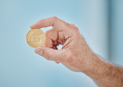 Buy stock photo Cropped shot of an unrecognisable businessman holding a bitcoin in the office