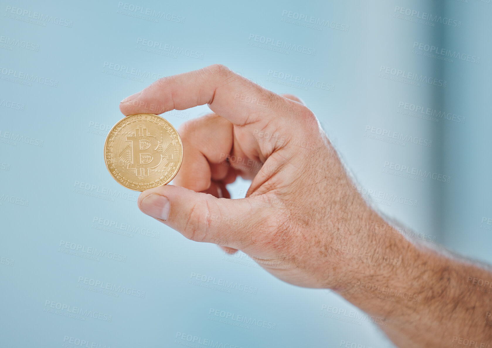 Buy stock photo Cropped shot of an unrecognisable businessman holding a bitcoin in the office