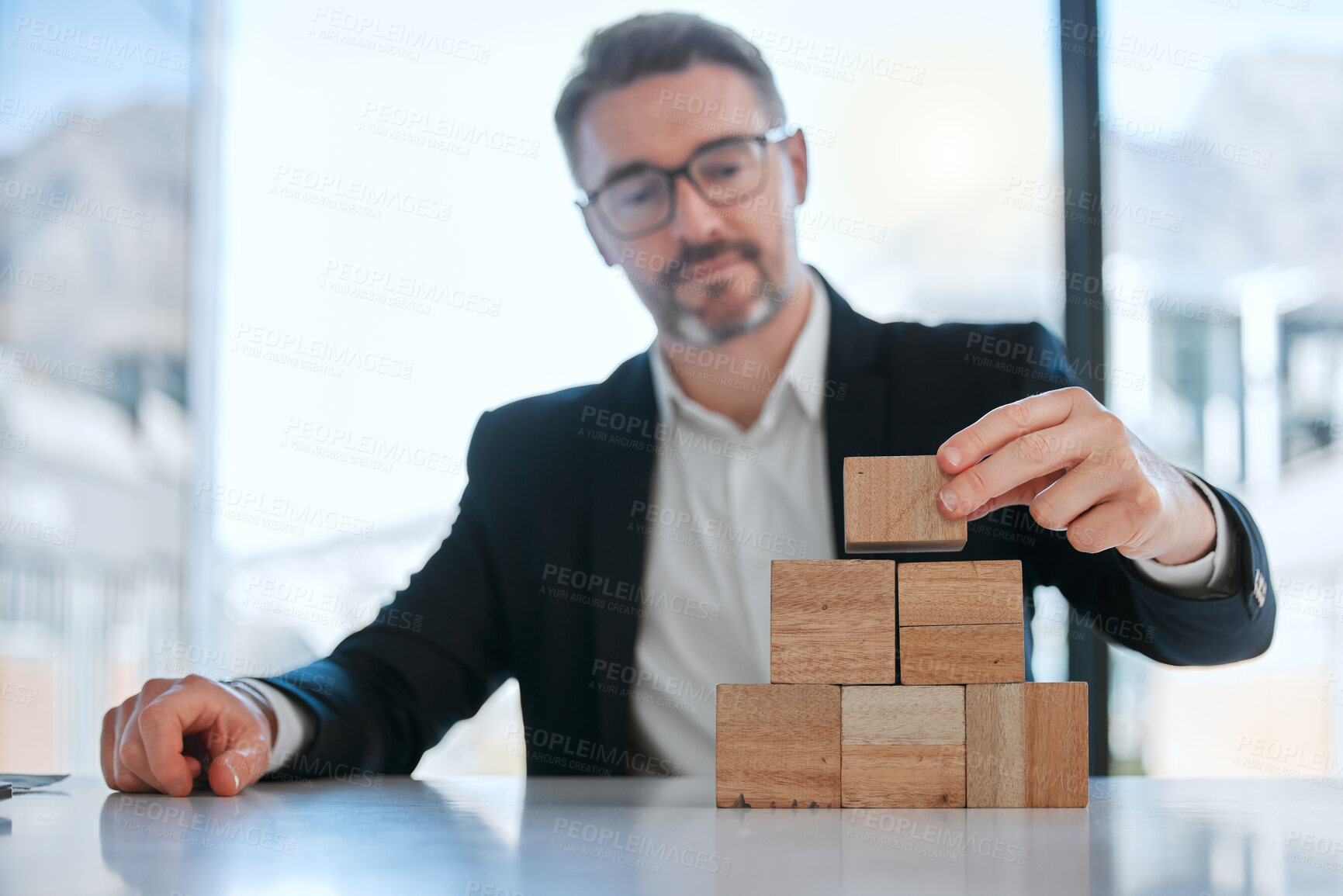 Buy stock photo Business man, office and building blocks on desk for planning strategy, investment growth and asset management. Corporate, male person and wood puzzle for security, insurance and financial stability