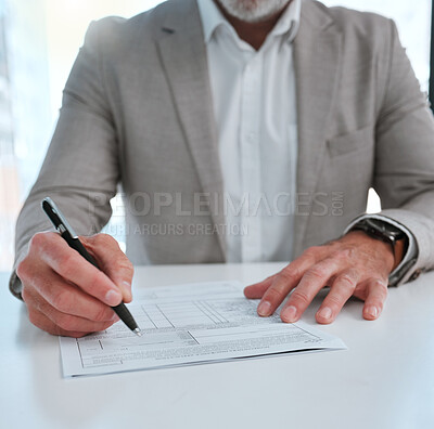 Buy stock photo Shot of an unrecognizable businessman filling in a form on a desk in an office
