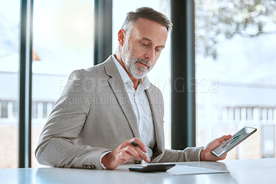 Buy stock photo Shot of a. mature man using a tablet and a calculator in a office