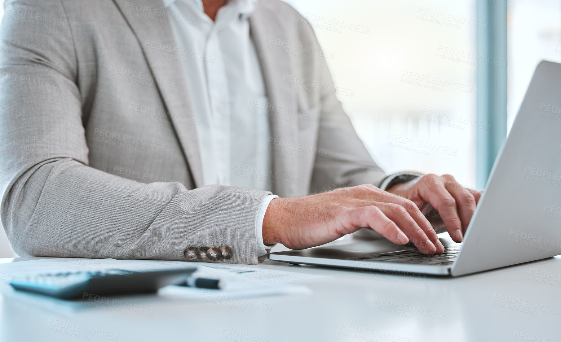 Buy stock photo Shot of a unrecognizable man using a laptop in a office