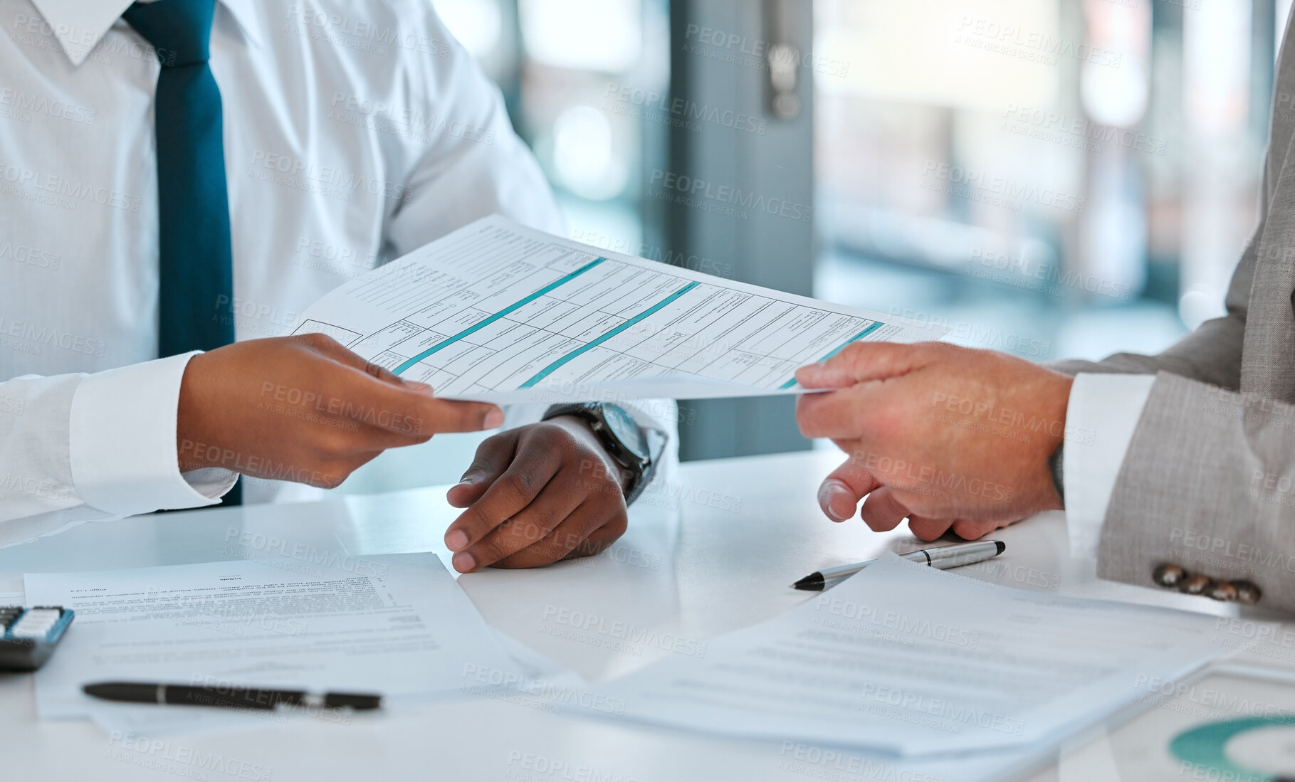 Buy stock photo Shot of two unrecognizable businessmen working on contracts in a office