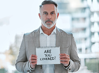 Buy stock photo Shot of a mature male holding a sign in a office